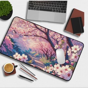 May include: A pink and purple mousepad with a scenic image of a path leading through a forest of cherry blossom trees. The trees are in full bloom with pink flowers. The mousepad has a black border.