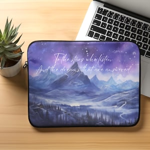 May include: Purple and blue laptop sleeve with a snowy mountain landscape and a quote that reads "To the stars who listen and the dreams that are answered."