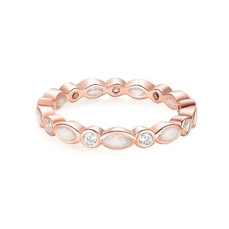 May include: Rose gold ring featuring alternating oval and round white gemstones. The ring has a continuous design with a polished finish. The gemstones are set in a repeating pattern around the band.