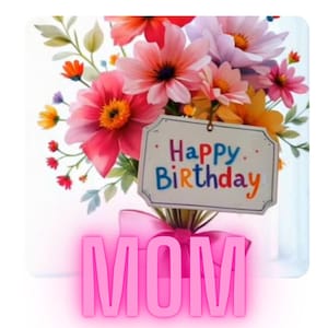 May include: A colourful floral arrangement featuring pink, red, and yellow blooms. A sign saying "Happy Birthday" is attached. The word "MOM" is displayed in large, pink letters below the flowers, tied with a pink ribbon.