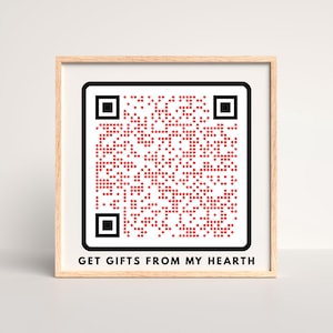 May include: A framed print featuring a QR code composed of red dots on a white background. The QR code is surrounded by a black border. Below the code, the text "GET GIFTS FROM MY HEARTH" is printed in black.