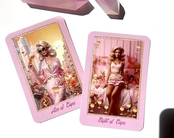 May include: Two pink tarot cards with illustrations and text, "Ace of Cups" and "Eight of Cups", are displayed with two iridescent pink crystals. The cards have a pink border and feature images of a woman in a pink setting.
