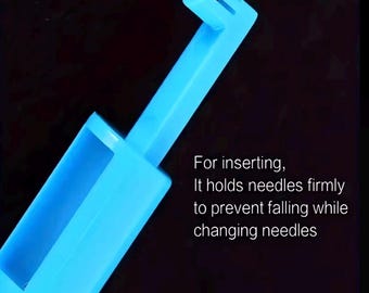 May include: A light blue plastic needle inserter tool. The tool has a rectangular base and an angled arm with a slotted end. Text on the image reads: "For inserting, It holds needles firmly to prevent falling while changing needles."