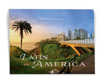 May include: A 2027 wall calendar featuring a landscape photograph of a coastal cliffside with a palm tree, a modern bridge, and city buildings in the background. The text "2027 Calendar" and "LATIN AMERICA" is printed in white on the image.