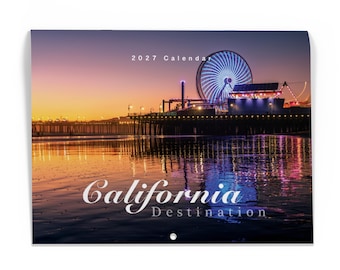May include: A 2027 calendar featuring a sunset photograph of a California pier with a large illuminated Ferris wheel. The text 2027 Calendar appears at the top, and the words California Destination are printed in white script and sans-serif font.