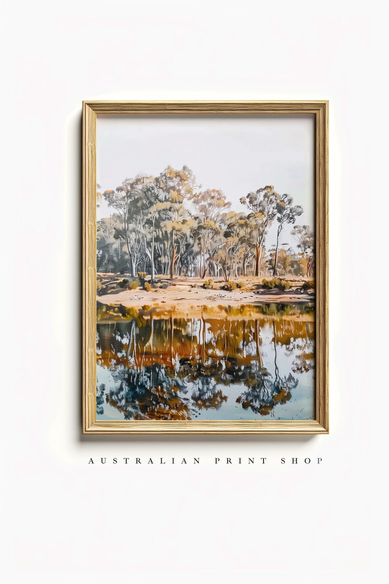 May include: A framed watercolor painting of a forest reflecting in a still body of water. The trees are a mix of green, brown, and yellow, and the water is a deep blue with hints of orange and yellow.