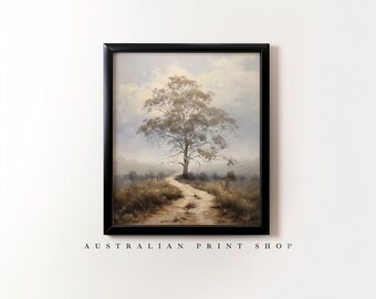 May include: A framed painting of a lone tree in a field with a dirt path leading to it. The sky is a light blue with white clouds. The painting is in a black frame.