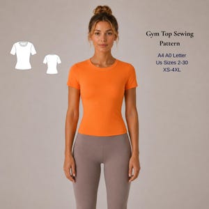 May include: An orange gym top with short sleeves and a round neckline. The model is wearing gray leggings. The image also includes a sewing pattern diagram and text that reads "Gym Top Sewing Pattern, A4 A0 Letter, US Sizes 2-30, XS-4XL."