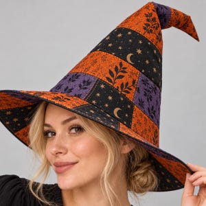 May include: A pointed hat featuring a patchwork design of orange, black, and purple fabric panels. The orange sections display a black leaf pattern, while the black sections are decorated with gold-colored crescent moons and small stars.