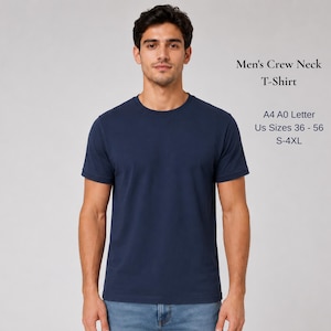 May include: A solid navy blue crew neck t-shirt with short sleeves. The text on the right reads: Men's Crew Neck T-Shirt, A4 A0 Letter, US Sizes 36 - 56, S-4XL. The shirt is worn with blue denim jeans, featuring a standard fit and a simple design.