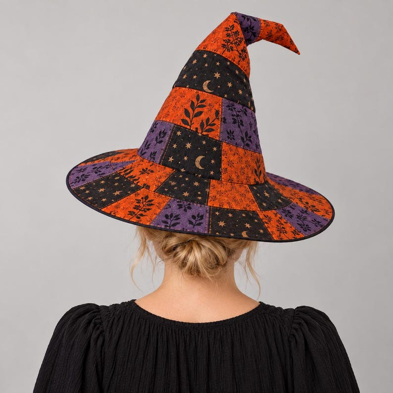 May include: A pointed witch hat featuring a patchwork design of orange, black, and purple fabric panels. The orange sections display a black leaf pattern, while the black panels are decorated with gold crescent moons and small star motifs.