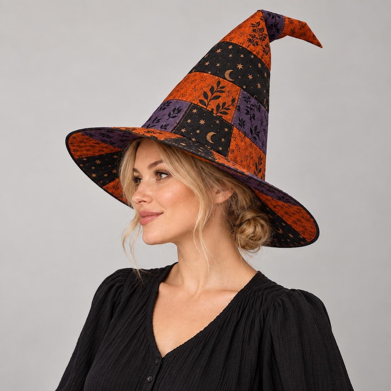May include: A pointed witch hat featuring a patchwork design of orange, purple, and black fabric panels. The fabric is decorated with repeating patterns of small stars, crescent moons, and leafy botanical sprigs across the conical crown and brim.