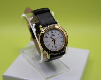 Orologio Timex Indiglo vintage con cinturino lungo in vera pelle, lunetta dorata e quadrante bianco unico.