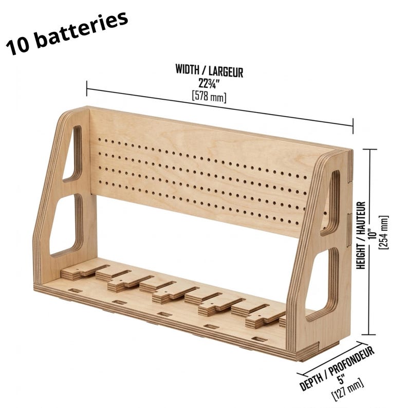 May include: A wooden battery organizer with a light brown finish. It features a series of slots for holding batteries and a perforated top section. The organizer is 22.75 inches wide, 10 inches high, and 5 inches deep. The text "10 batteries" is visible.