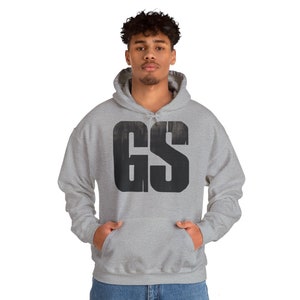 May include: A grey hooded sweatshirt with a black "GS" logo printed on the front.