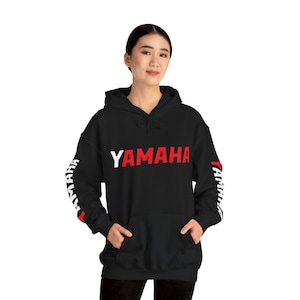 May include: Black hooded sweatshirt with white and red "YAMAHA" lettering on the front and white "YAMAHA" lettering on the sleeves.
