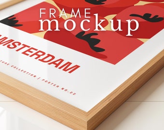 May include: A wooden frame mockup with a poster inside. The poster features a red, yellow, and black abstract design with the text "AMSTERDAM" and "FRAME mockup".