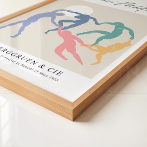 May include: A framed art print featuring a colorful abstract design of five figures in a circle. The print is titled "Henri Matisse" and includes the text "ERGGRUEN & CIE 27 Fevrier au Samedi 28 Mars 1953".