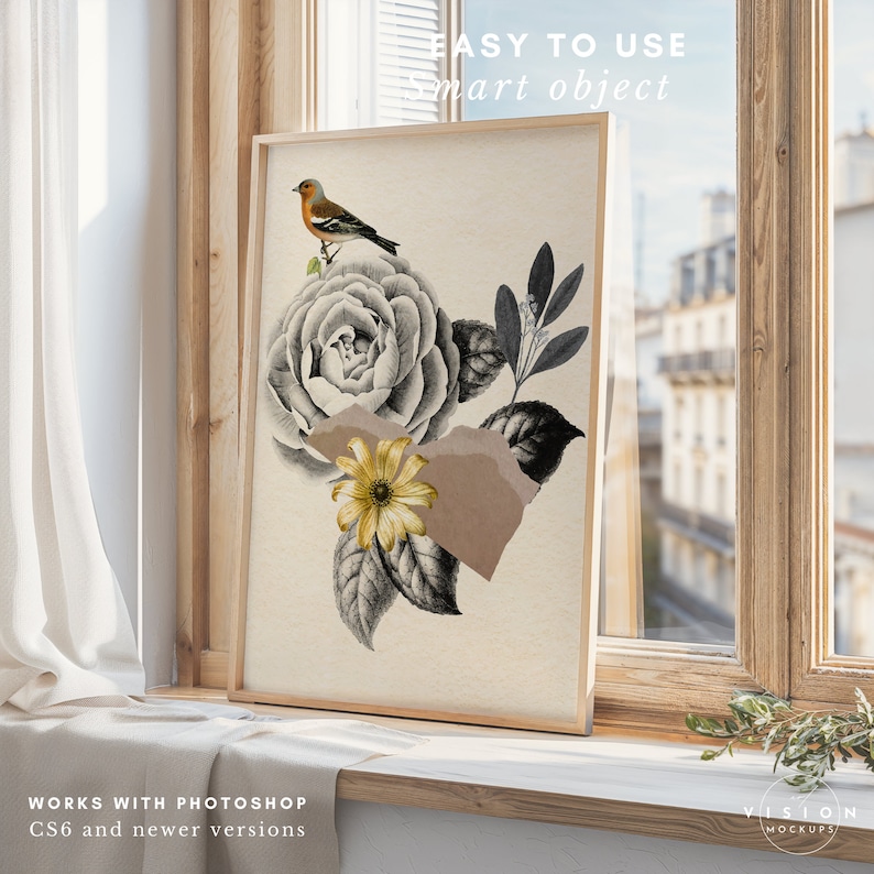 May include: A framed print of a floral illustration with a bird perched on a flower. The illustration is in black and white with accents of gold and brown. The frame is a light wood color.
