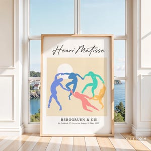 May include: A poster featuring a painting by Henri Matisse titled "Dance (I)". The painting depicts five figures in a circle, dancing against a light yellow background. The figures are outlined in blue, green, pink, and yellow. The text "BERGGRUEN & CIE" and "Du Vendredi 27 F&eacute;vrier au Samedi 28 Mars 1953" is printed at the bottom of the poster.