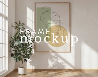 May include: A framed illustration of a woman with a bun in her hair, wearing glasses and a green and yellow abstract background. The frame is made of wood and has a light brown finish. The text "FRAME MOCKUP" is superimposed on the image.