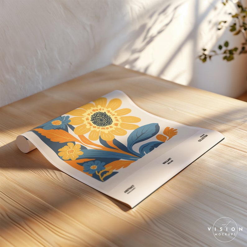 May include: A rolled up floral wallpaper with a yellow, orange, and blue design. The wallpaper is on a wooden surface. The text on the wallpaper reads "Wall Art Collection".