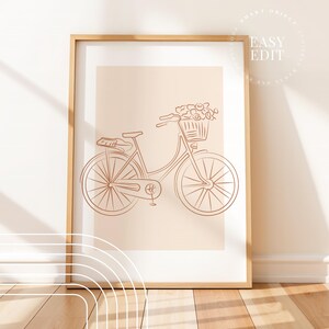 May include: A line drawing of a bicycle with a basket of flowers on a peach background. The bicycle is brown and the flowers are pink.