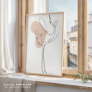 May include: A framed print of a line drawing of a crane with a pink and gray abstract background. The print is hanging on a wall with a window behind it.