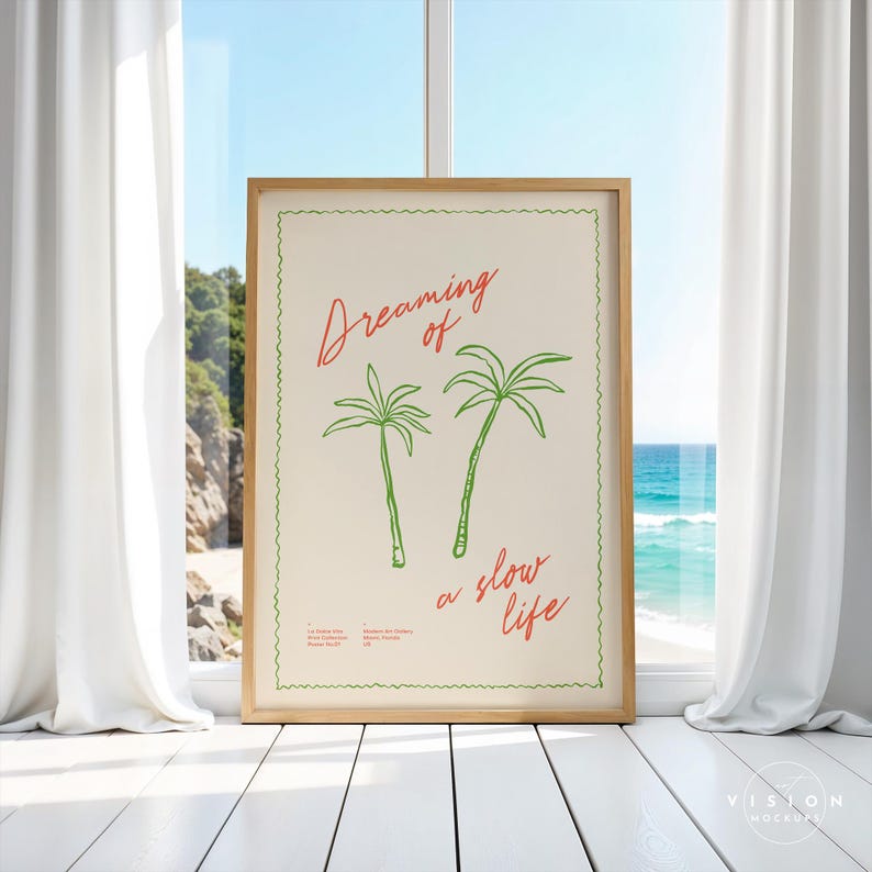 May include: A framed print with a white background and green palm trees. The text "Dreaming of a slow life" is written in red cursive.