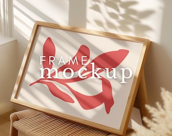 May include: A wooden frame mockup with a red abstract leaf design on a cream background. The text "FRAME mockup" is printed in white on the image.