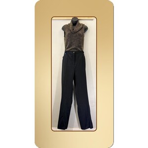 May include: A sleeveless brown and gold cowl neck top and black trousers. The outfit is displayed on a mannequin. The trousers are high-waisted with a straight leg design. The top has a textured appearance.