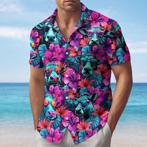 May include: Short-sleeved button-down shirt with a vibrant pattern of cartoon cows wearing sunglasses amidst colorful hibiscus flowers. The shirt features a dark blue background with pink, red, and turquoise accents, creating a tropical theme.