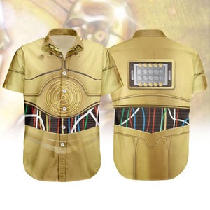 May include: A short-sleeved button-down shirt featuring a gold and brown design reminiscent of a famous droid. The front of the shirt has a circular design with a series of colored wires. The back of the shirt has a rectangular panel with lights.