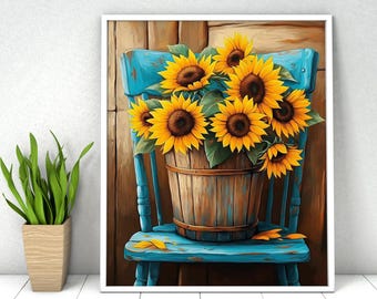 May include: A framed wall art print featuring a wooden bucket filled with bright yellow sunflowers resting on a distressed teal blue wooden chair. The background consists of vertical brown wooden planks, creating a rustic composition of flowers.