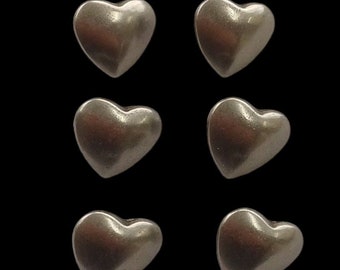 May include: Six silver heart-shaped buttons.