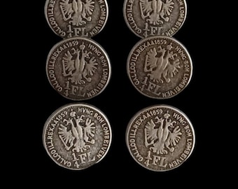 May include: Six silver coins with the text "GALLODILLREXAA1859 HVNG BOH LOMBEIVEN" and "1/4 FL" on them.