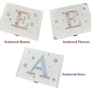 Peut inclure: Trois bo&icirc;tes d&eacute;coratives avec des lettres et des noms personnalis&eacute;s. Les deux premi&egrave;res bo&icirc;tes ont une lettre "E" rose avec le nom "Elste" et sont d&eacute;cor&eacute;es de c&oelig;urs et de fleurs. La troisi&egrave;me bo&icirc;te a une lettre "A" bleue avec le nom "Alexander" et est d&eacute;cor&eacute;e d'&eacute;toiles.