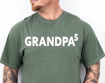 May include: A green t-shirt with the text "GRANDPA5" printed in white on the front.