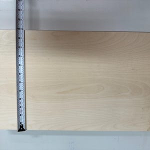 May include: A light wood board measuring 12 inches in length.