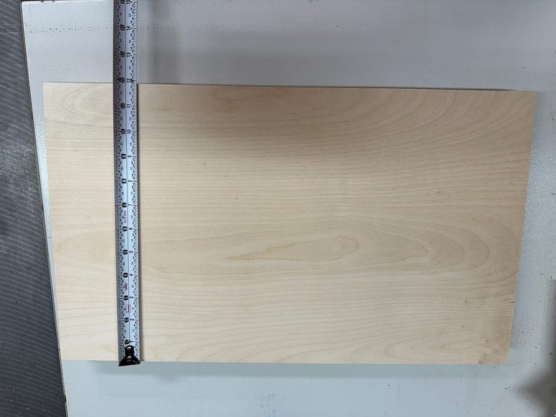 May include: A light wood board measuring 12 inches in length.