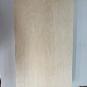 May include: A plain, light brown wood panel with a smooth surface and visible wood grain.