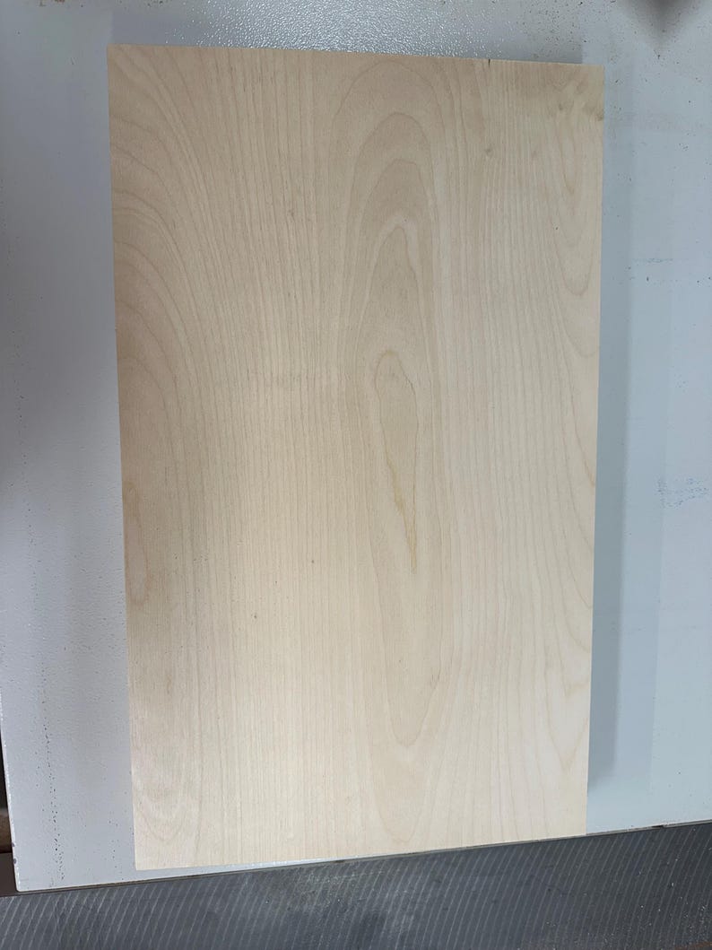 May include: A plain, light brown wood panel with a smooth surface and visible wood grain.