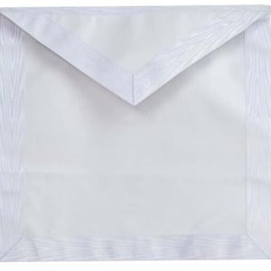 May include: White Masonic apron with a white satin border and a white satin flap.