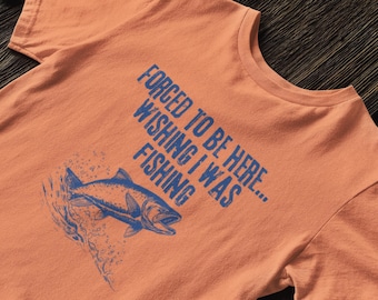 May include: Orange t-shirt with a blue graphic of a fish and the text "Forced to be here... Wishing I was fishing."