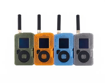 May include: Four portable radio transceivers arranged in a row, featuring olive green, orange, blue, and gray textured cases. Each device includes a black antenna, a square display screen, and a circular control pad with a black center button.