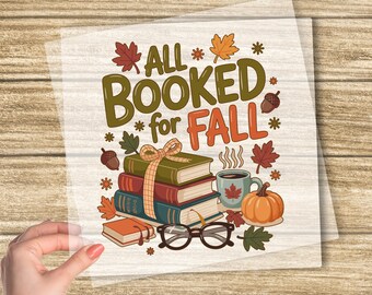 May include: A DTF transfer with the text "ALL BOOKED for FALL" in green and orange, featuring books, a pumpkin, coffee, and fall leaves. The words "CUSTOM DTF TRANSFER" and "READY TO PRESS" are also visible.