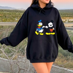 Disney Mickey Mouse and Donald Duck Best Friends Hoodie, Disneyland Matching Hoodie, Mickey Sweater, Mickey friend Shirt, Gift For bestie
Disney hoodie
Hooded Sweater
magic kingdom tee
disneyland family
matching shirt
disney mickey mouse
donald duck
best friends gift
mickey and friends
birthday gifts
retro mickey
disney trip
gift for bestie
