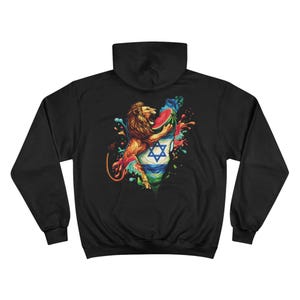May include: Black hoodie featuring a colorful graphic of a lion embracing a map with the Star of David. The design includes a watermelon and vibrant splashes of color, creating a bold and artistic statement. The hoodie has a hood and long sleeves.