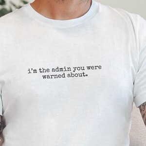 May include: A white ceramic mug with a black handle and the text "But First, Coffee" in a black, bold font. The mug is on a white surface. The mug is approximately 4 inches tall.