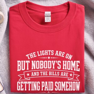 Funny Adult Humor Shirt, Sarcastic Adulting Tee, The Lights Are On But Nobody's Home and Bills Are Getting Paid Somehow, Gen X Gift image 8